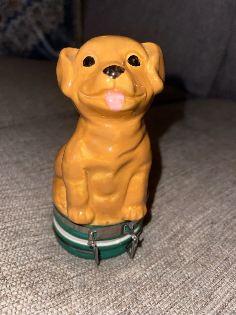 Ceramic dog figurine that has storage in the bottom.